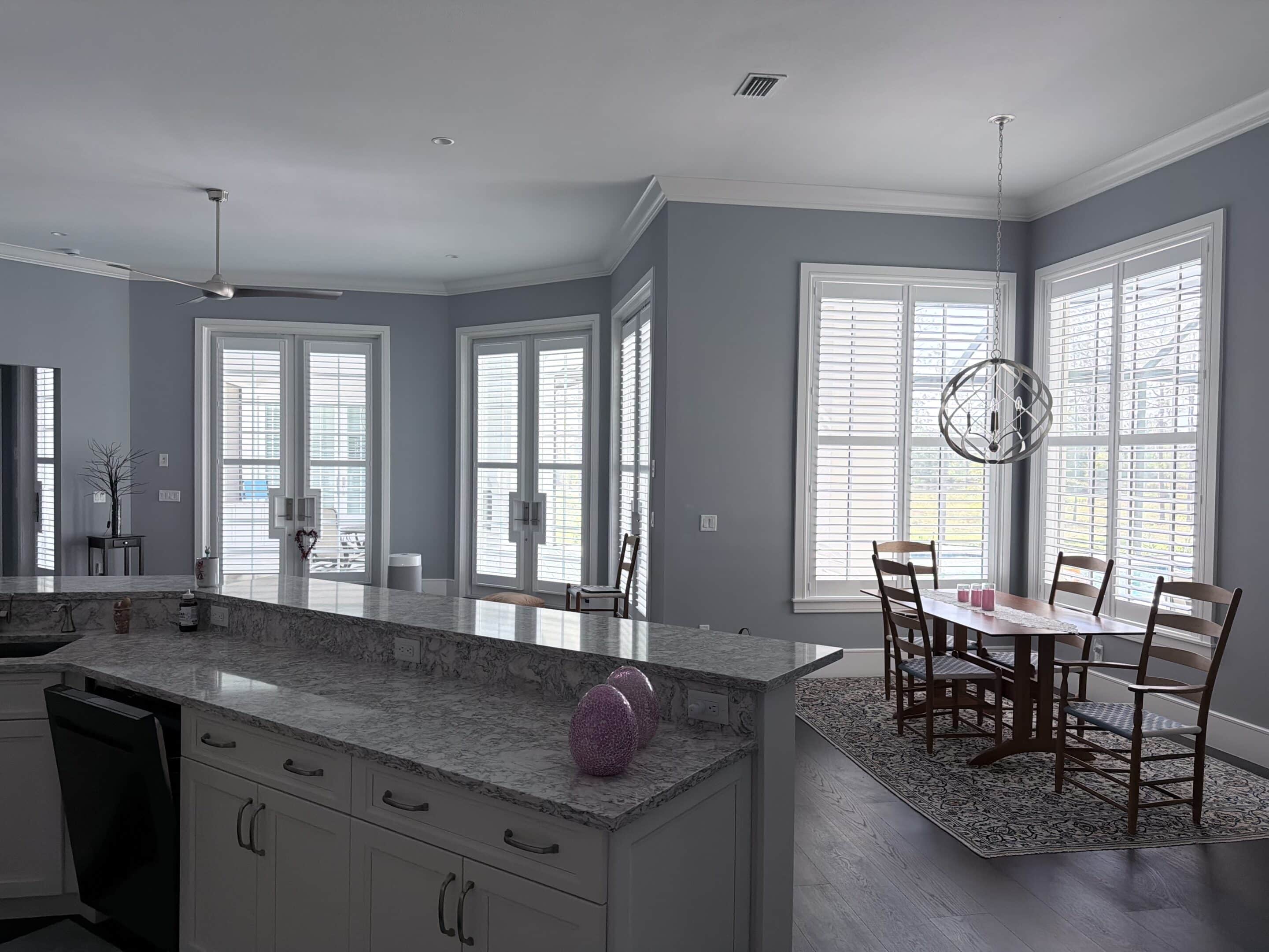 White plantation shutters on french doors and windows in a Lake Highlands, Dallas kitchen and dining area