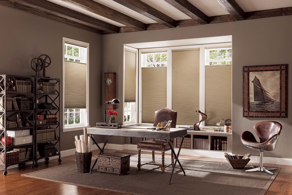 Tan cellular honeycomb shades on bay and side windows in a Dallas home office